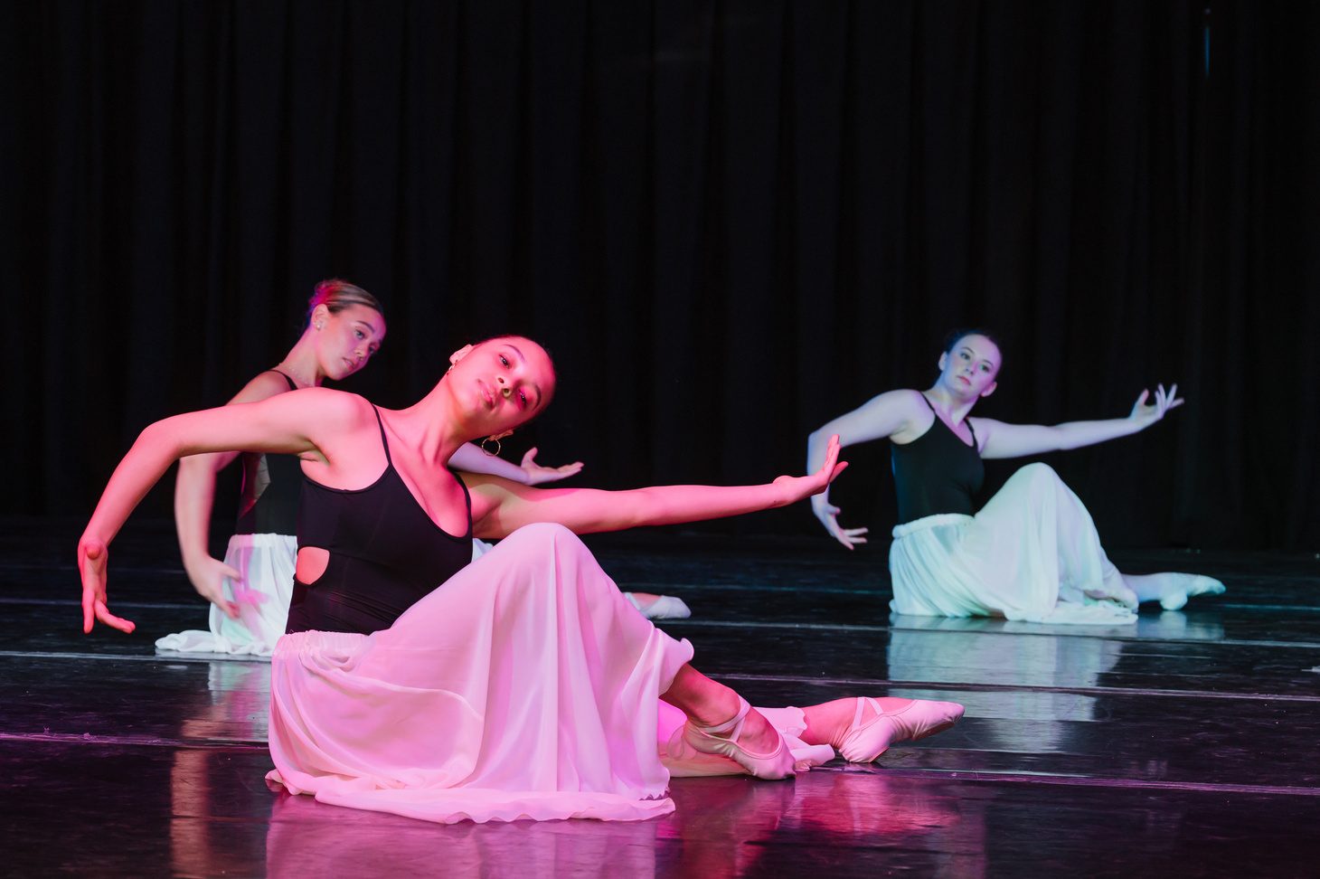 Soloist in a pink costume mid-performance on stage