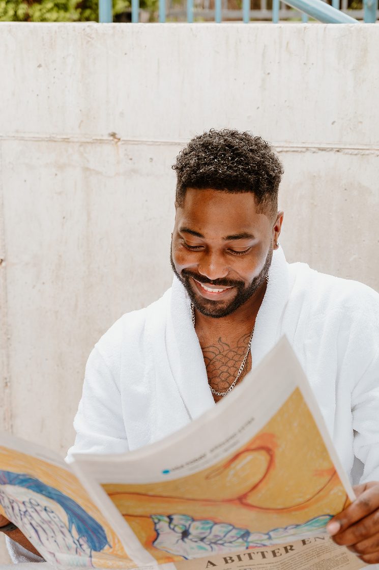 Hotel guest in a robe enjoying an in-room amenity
