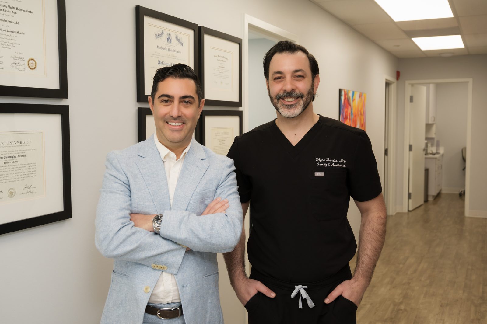 Two practitioners photographed inside a modern medical aesthetics clinic